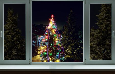 Christmas tree in flames outside the windowの写真素材