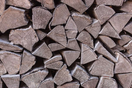 gray firewood stacked in a woodpileの写真素材