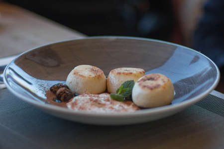 Appetizing cheese cakes with mint sauceの写真素材