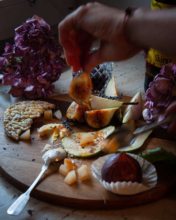 Plate with figs, pear and fresh cheeseの写真素材