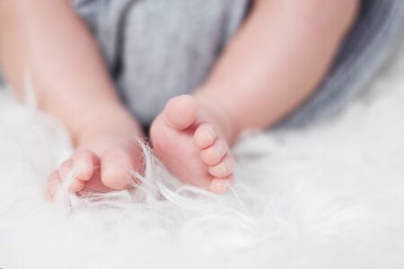 Newborn feet on white blanketの写真素材