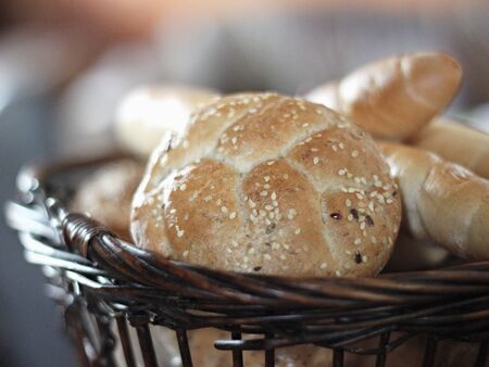 Fresh bread in the basket on the tableの写真素材