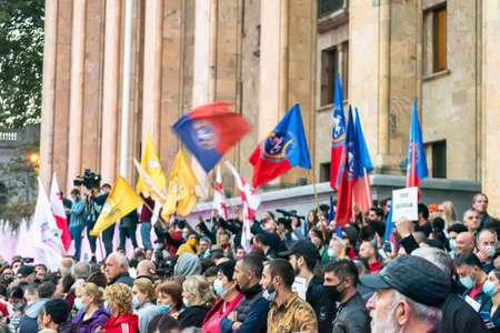 1 november, 2020. Tbilisi.Republic of Georgia. Crowd of people with posters and flags standing in front of parliament building during post election protest.のeditorial素材