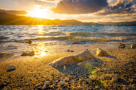 Crashing wave to the rock and Salda lake during the sunset and windy conditions. Clouds and sunrise...