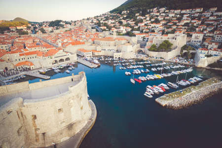 Harbour with no tourists in Dubrovnik ith many ships parked on dock during the sunrise.の写真素材