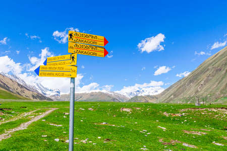 Sign post with hiking; cycling route and paths surounded by landscape in KAzbegi national parkの写真素材