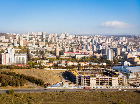 Olympc palace building with stadium construction site and Saburtalo district area real estate buildings in the backgroundの写真素材