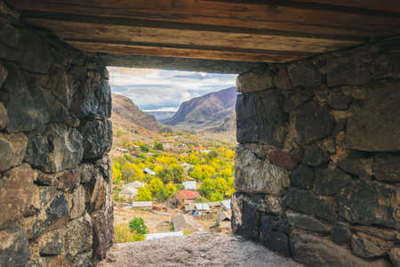 View down from the window of Khertvisi fortress to nature and houses in countryside of vardzia. Historical places and sightseeing in Georgia.のeditorial素材