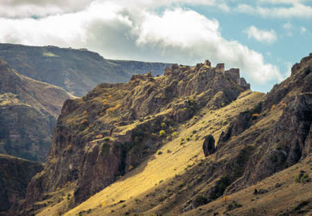Landscape view of Tmogvi fortress on the hill from distance with dramatic sky above. Historical sites in Georgia.のeditorial素材
