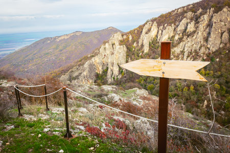 Blank space Wooden direction board to the left with panoramic scenic view of Eagle canyon in Georgia.の写真素材