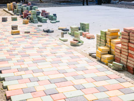 New Colorful pedestrian footpath layed with new colorful square bricks stand on sideの写真素材