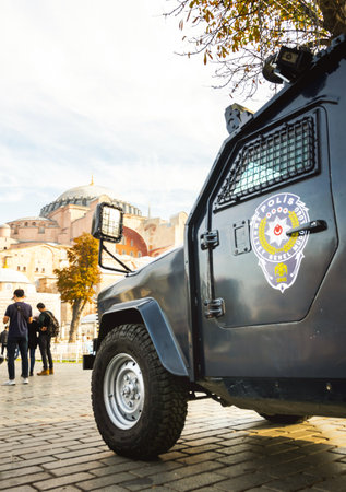 Istanbul, Turkey - November 25th, 2021: Polis armored vehicle standing on duty in Sultanahmet area with tourists and museum in the background. Safety and security in touristic places in Turkey concept.のeditorial素材