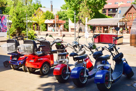 Palanga, Lithuania -14th June, 2021: Many colorful fat tyre electric scooters parked for rent in public famous Lithuania sea resort.のeditorial素材