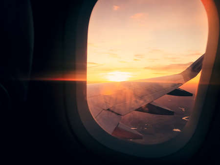 In plane flight view from window with stunning sunset background and copy paste vertical backgroundの写真素材