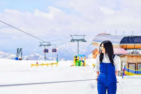 Caucasian woman skiers portrait on baby lift learning to ski in winter resort. Ski holidays in...