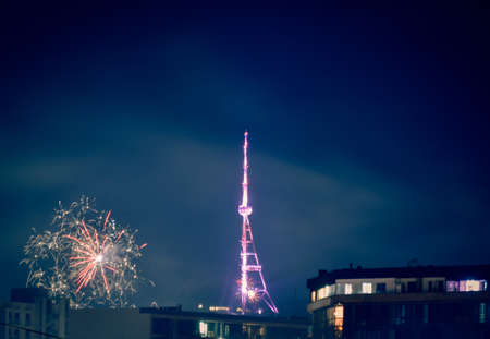 Beautiful night landscape with salute and fireworks by captal Tv tower on Mtantsminda hill in...