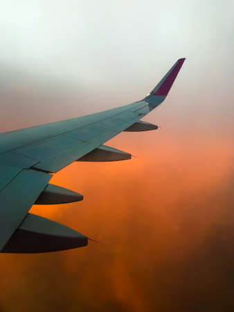Hazy airplane wing view sunny cinematic panorama during flight over land copy paste vertical...