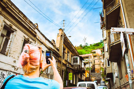 Tbilisi, Georgia - 30th april, 2022: tourist take photo of old town buildings in street of capital of Georgiaの写真素材