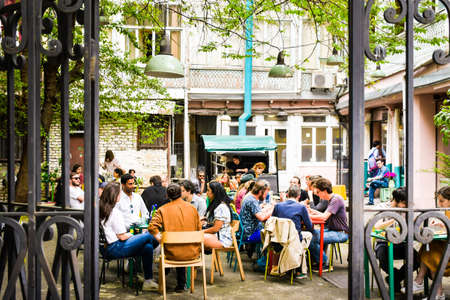 Tbilisi, Georgia - 30th april, 2022: people tourist sit in courtyard restaurant outdoors in sololaki area old town Tbilisiのeditorial素材