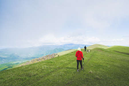 Female hiker nordic walk trekking outdoors in spring nature. Ikvlivi mount loop hike.の写真素材