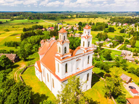 Kurtuvenai, Lithuania - 25th june, 2021: Aerial view St. Jacob the apostle church in Kurtuvenai town, with Lithuania countryside panorama backgroundのeditorial素材