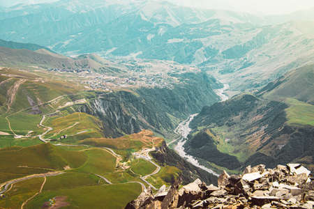 Aerial fly over view KAzbegi national park in caucasus mountains. Russia Georgia Friendship Monument...