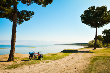 Close up touring bicycle stand on scenic nature countryside by sevan lake. Fully loaded touring machine with copy space backgroundの写真素材