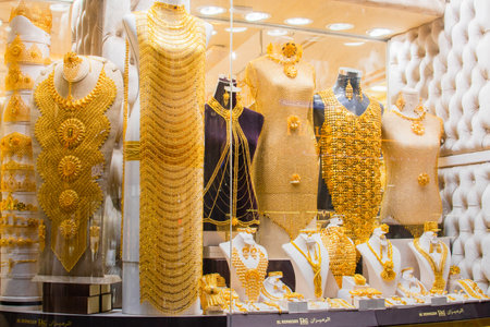 Dubai, UAE - 12th october, 2022: most expensive shop items - luxury golden dresses and outfits for woman on shop display in gold souk in old Dubaiのeditorial素材