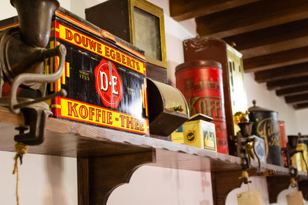 Dubai, UAE - 12th october, 2022: old vintage retro coffee containers on wooden shelf in coffee museum in Dubaiのeditorial素材