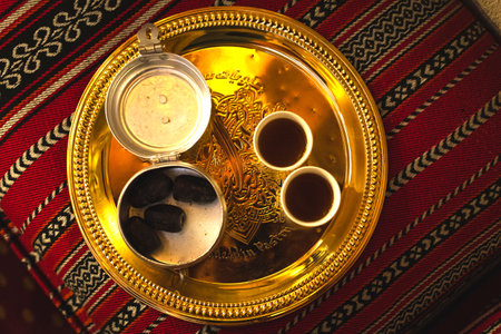 Dubai, UAE - 12th october, 2022: Top view coffee set up on silver plate of two cups and dates in bowl in coffee museum in Dubaiのeditorial素材