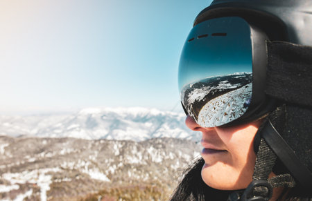 Close up skiers female person goggles with mountains panorama reflection. Ski holiday in caucasus mountainsの写真素材
