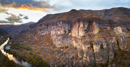 Dramatic aerial view to Vardzia cave city with paravani river and sunset in the background, Travel and sightseeing in Georgia.Unesco sites in caucasus. 2020の写真素材
