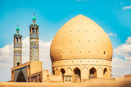 View of traditional minarets and domes in Yazd at sunset, Iranの写真素材