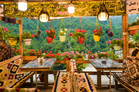 Masuleh, Iran - May 2022: beautiful flower decorations in cafe with seats in Masouleh village.のeditorial素材