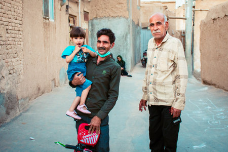 Kashan, Iran - 10th june, 2022: Iranian man father hold daughter by grandfather in Kashan. Local community. Muslim traditions and culture in Iranのeditorial素材