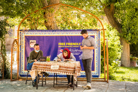 Isfahan, Iran - iranians sit learn symbols to write in Farsi language display corner in Isfahan Jame mosque courtyardのeditorial素材