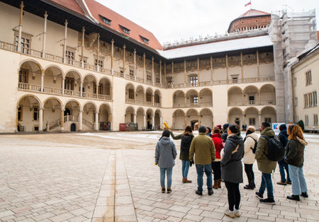 Krakow, Poland - 6th march, 2023: guide with tour group in in Krakow Wawel Royal castle yard. Free tourist walking tours with locals. Unique experience in new cityのeditorial素材