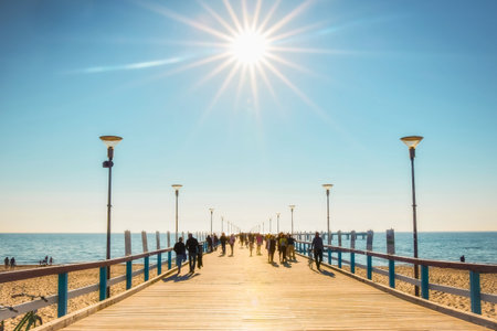 Palanga, Lithuania - 6th June, 2021: Palanga pier with tourists walking in heat in sunny summer day. Lithuania holiday destination.のeditorial素材