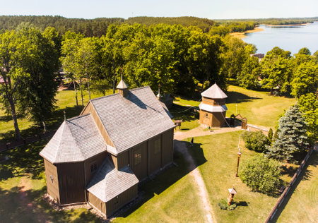 Aerial view Young lithuanians relax on sunday mass by St. Joseph Church in Paluse, Lithuania. Stave...