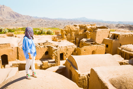 Woman tourist on viewpoint sightseeing Kharanaq, traditional and historic village in Iranの写真素材