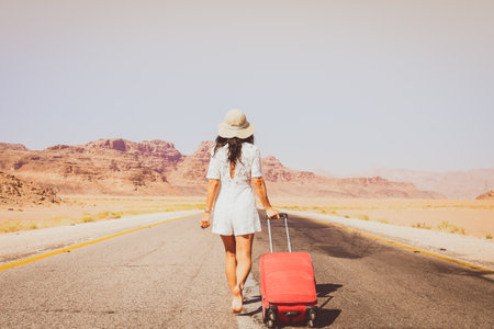 Cute young woman traveler on road dream about travel outdoors. Vintage travel carefree holiday tourism conceptの写真素材