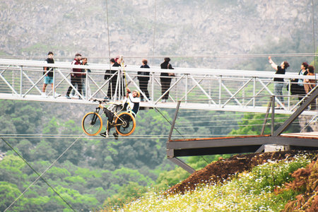 Dashbashi, Georgia- 19th JUne, 2022: staff help male rider on zip bike over valley in beautiful caucasus mountainsのeditorial素材