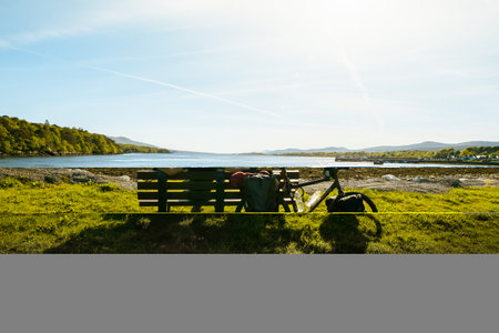 Cyclist enjoy panoramic view on break time by atlantic coast beach on bicycle touring around Irelandの写真素材