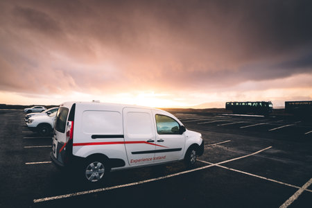 Reykjavik, Iceland - march 15th, 2023: white camper van stand in parking lot in Iceland with sunset...
