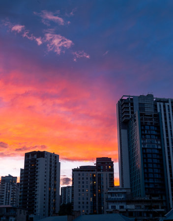 Saburtalo new high rise real estate buildings with dramatic purple orange sky in motion blue hour...