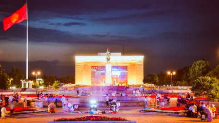 Bishkek, Kyrgyzstan - 25th september, 2023: tourist visit Manas Statue in Ala-Too Square. State history museum and fountain with tourist in city square. Sunset blue hour sky backgroundの写真素材
