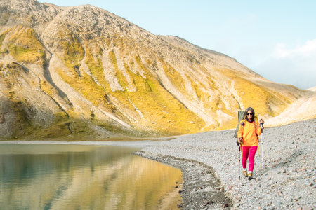 Woman hiker solo hiking by Kelitsadi lake in Georgia caucasus mountains. Nature therapy relaxation outdoors. Active lifestyle sports outdoorsの写真素材