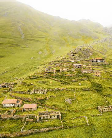 Aerial top view abandoned village of Arsha ruins on hillside. Kazbegi national park. Hidden gem sightseeing attraction in Georgia caucasus mountainsの写真素材