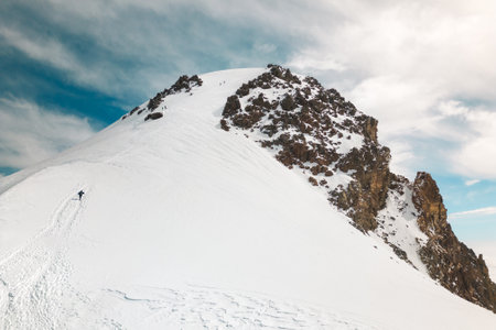Aerial view group of climbers two above clouds climb reaching famous Mount kazbek peak in Georgia. Mount Kazbek or Mount Kazbegi is dormant stratovolcano - major mountains of the Caucasus.Summit pushの写真素材