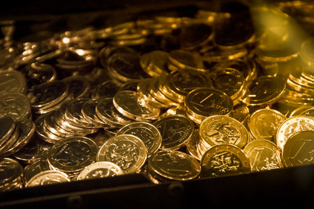 A one Euro coins in chest from the EU member country Lithuania.Close up many golden new euro coins...